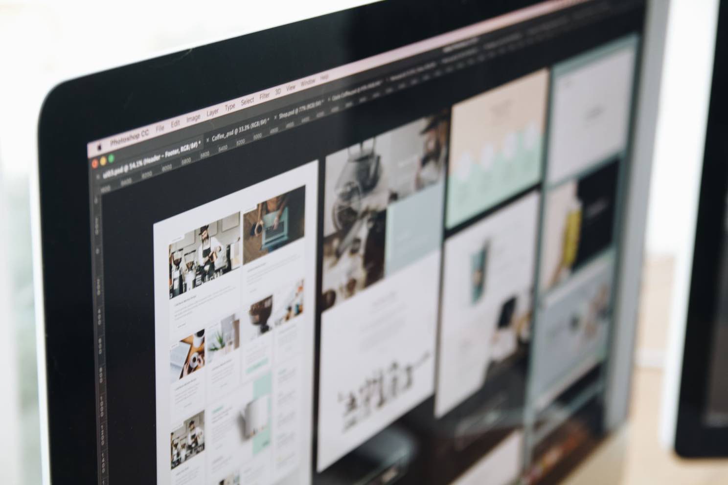 A designer reviewing website mockups and layout options on a large screen